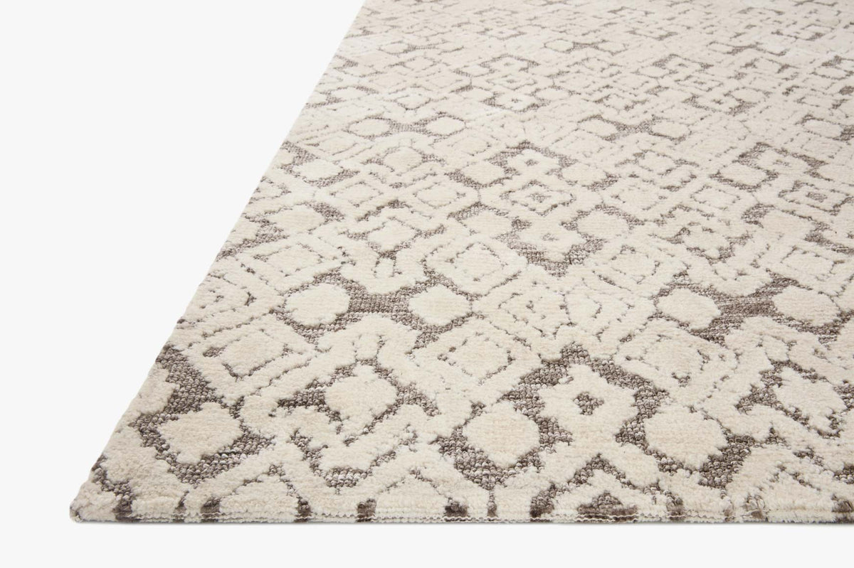 Corner view of transitional rug: ivory background with gray diamond quatrefoil pattern