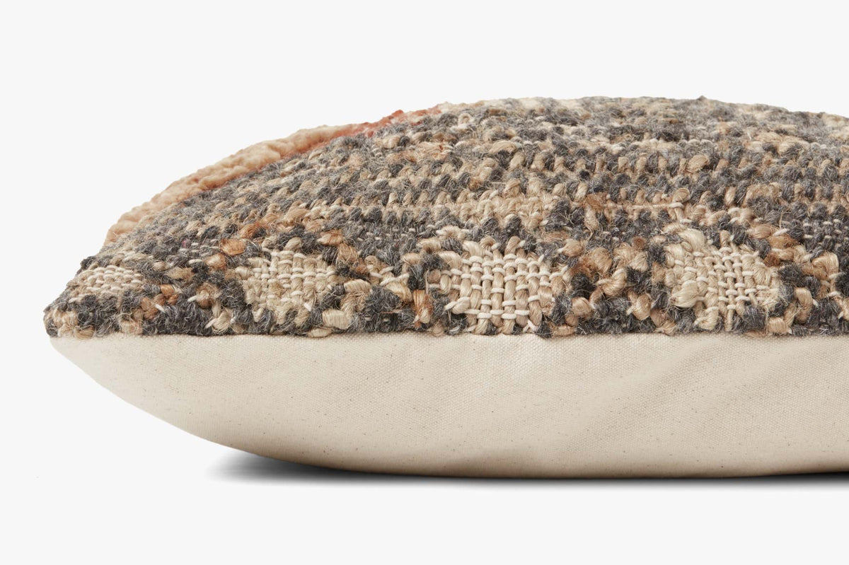 Charcoal woven pillow with tan and rust geometric pattern and textured fringe