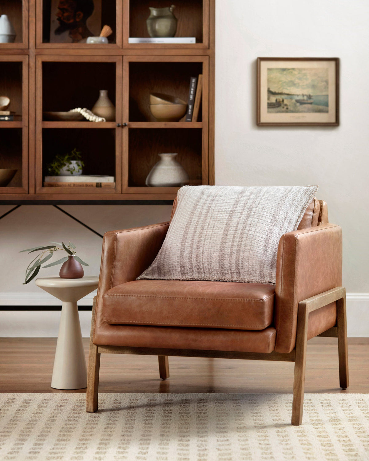Square pillow on chair featuring ivory woven fabric with beige vertical stripes