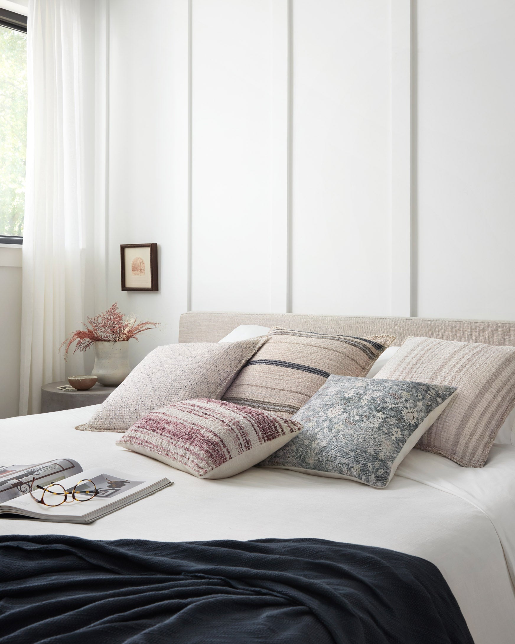 Decorative bed pillow with textured ivory fabric and beige stripe bands