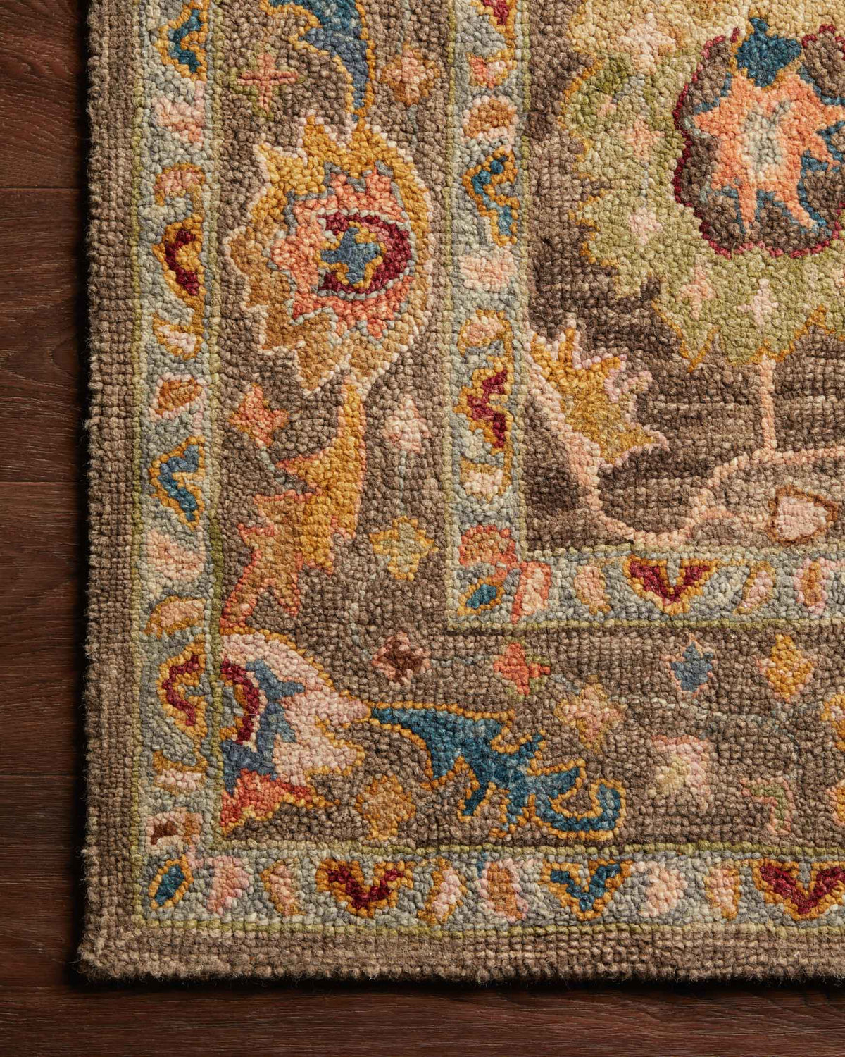 Charcoal hooked rug texture with multicolor floral motifs and looped pile
