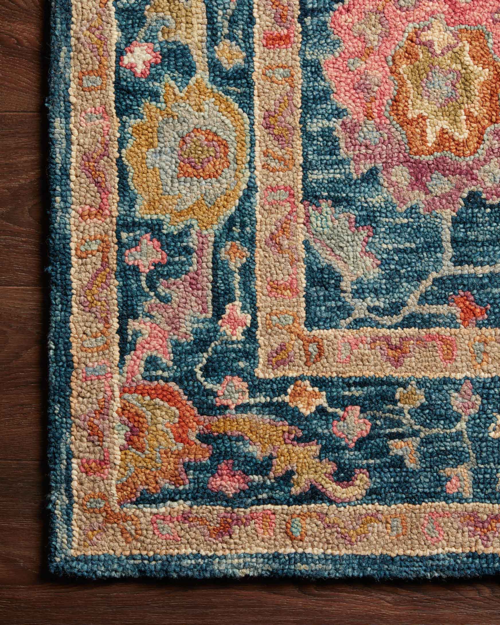 Hooked rug pile detail in marine blue with multicolor floral pattern close-up