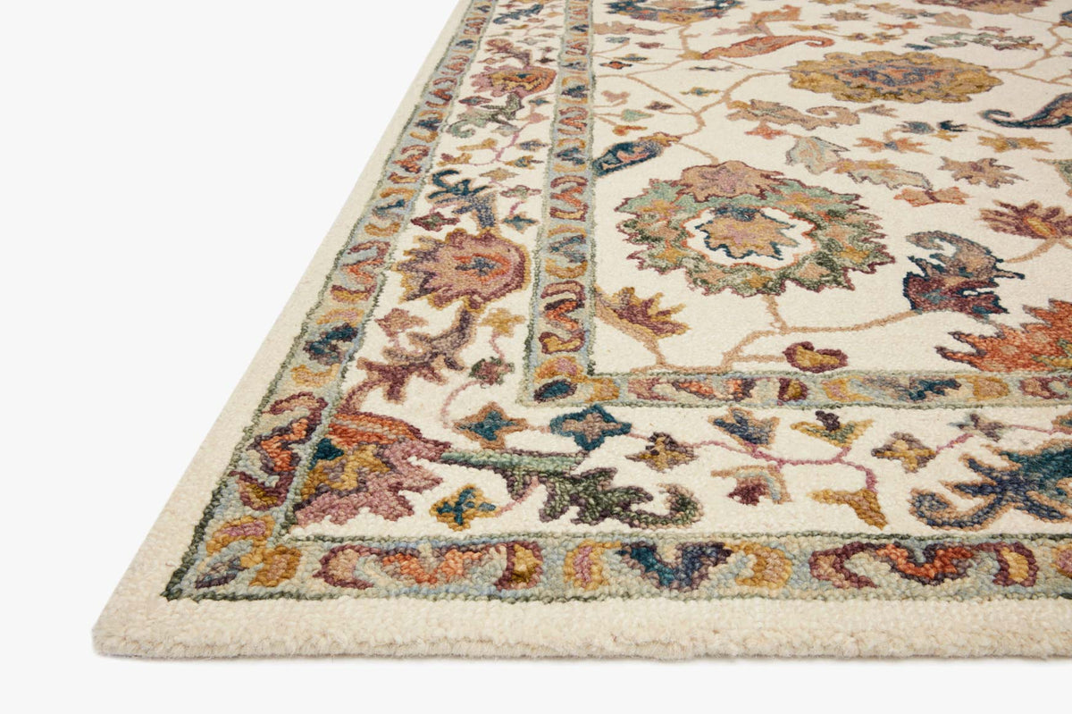 Transitional hooked rug corner, white background with multicolor floral pattern and border
