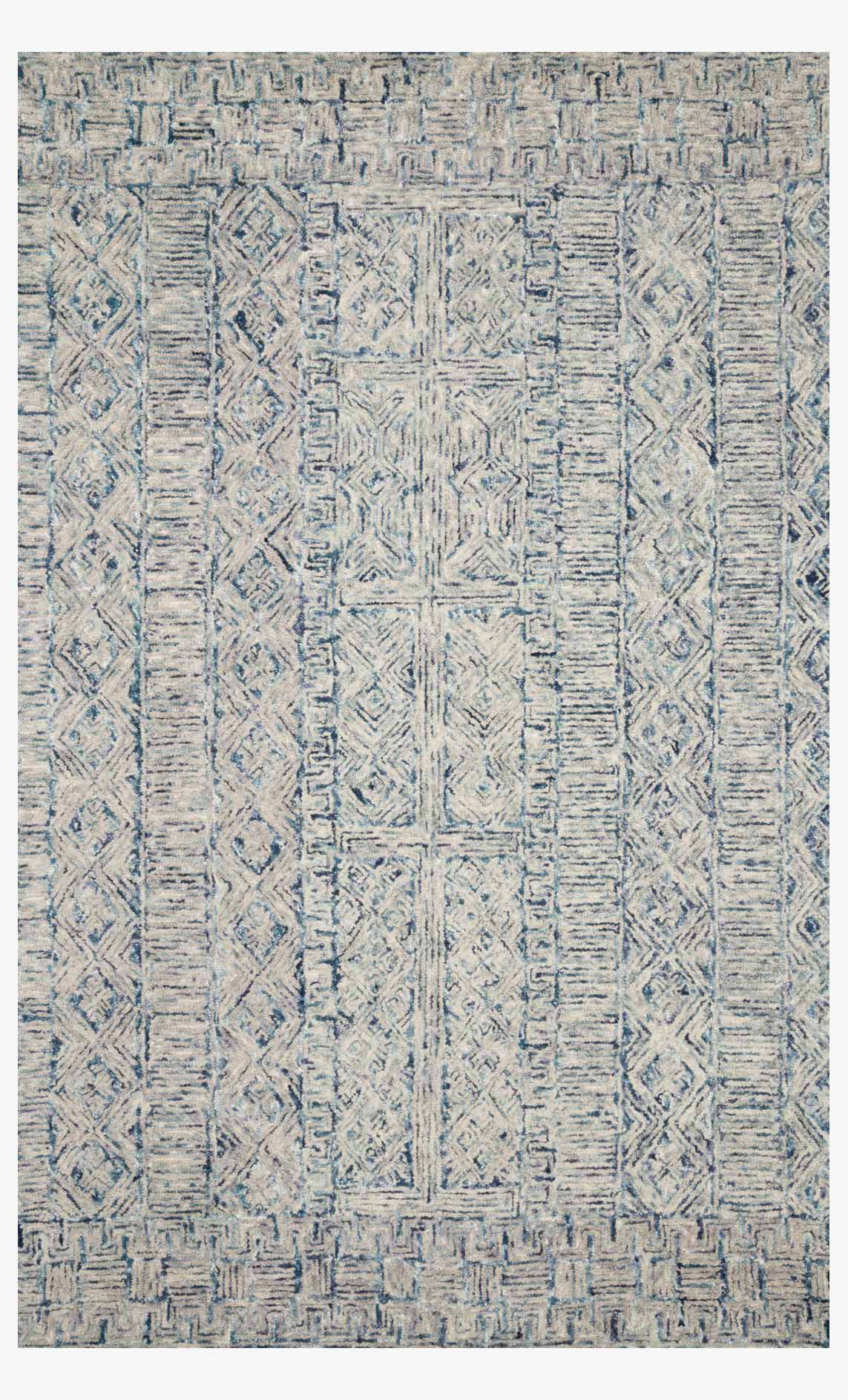Hand-tufted area rug in ocean blue with geometric patchwork pattern and textured pile