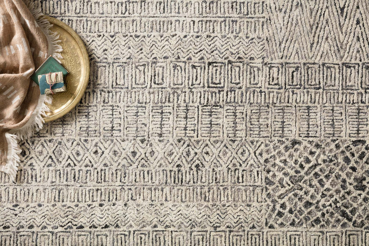 Charcoal hand-tufted rug detail with maze-like lines and diamond motifs