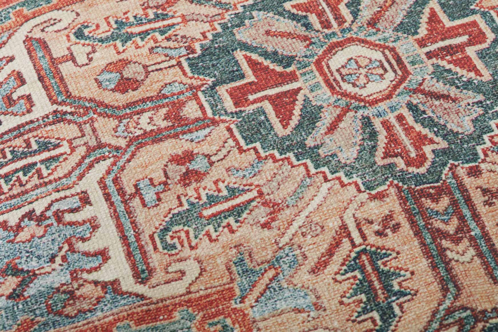 Woven geometric pattern on pouf fabric in rust, teal, and cream