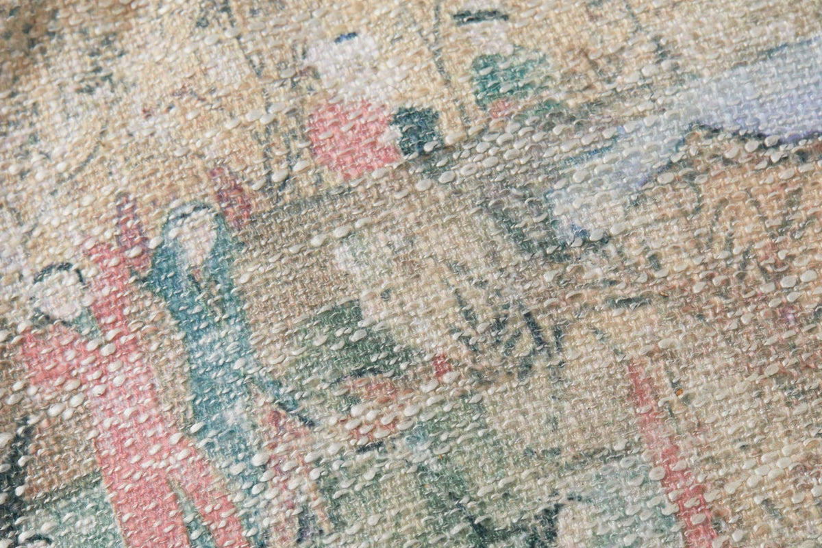 Woven pouf fabric close-up in beige with blue and pink abstract motifs