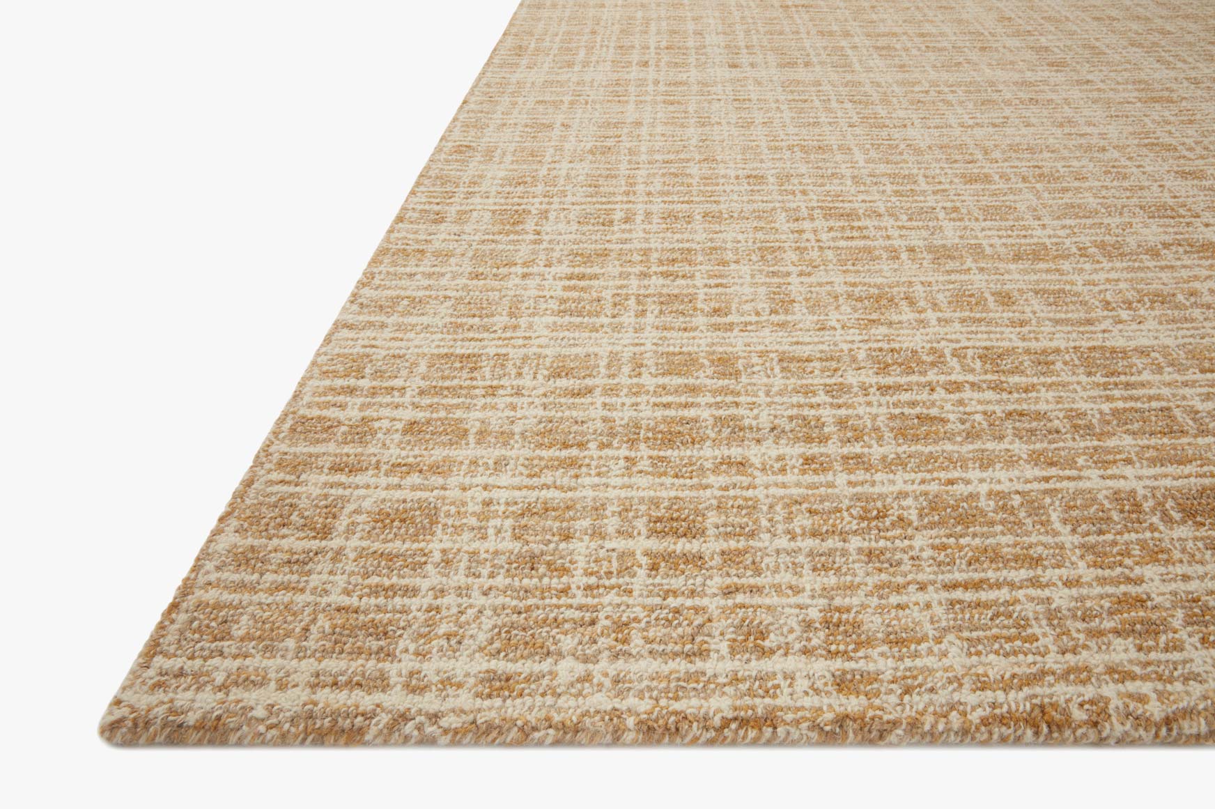 Straw and ivory hand-tufted area rug with low-pile textured pattern from a corner view.