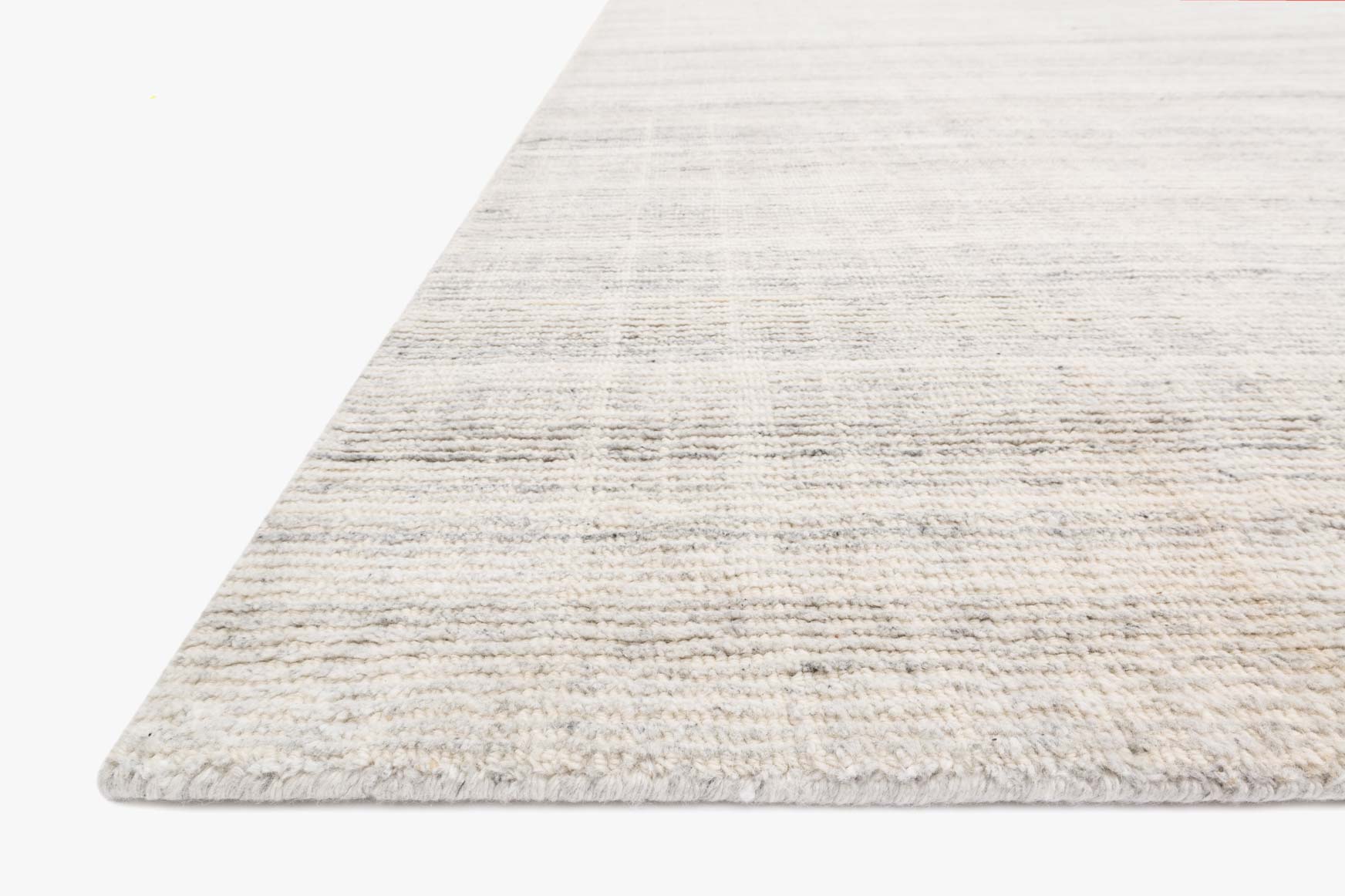 Silver hand-loomed rug with textured horizontal bands and visible short pile edge