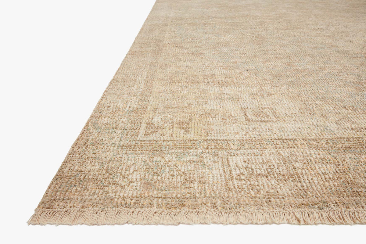 Ivory and ocean hand-woven rug corner with subtle pattern and short fringe trim