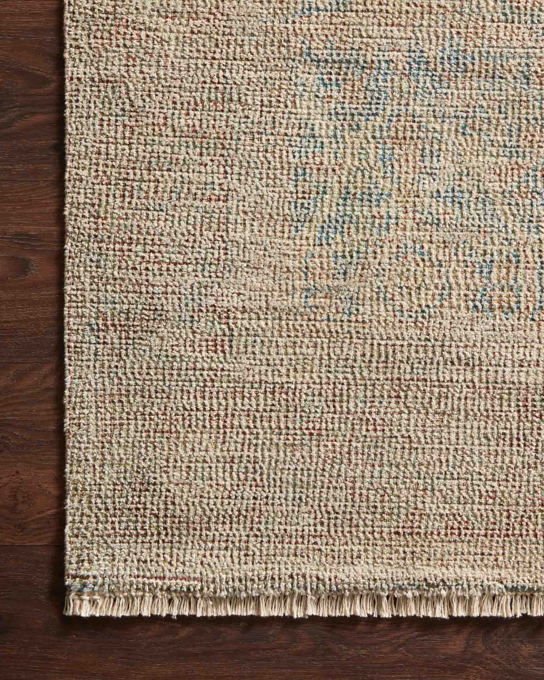Transitional hand-woven rug close-up in denim blue and rust with textured flat weave
