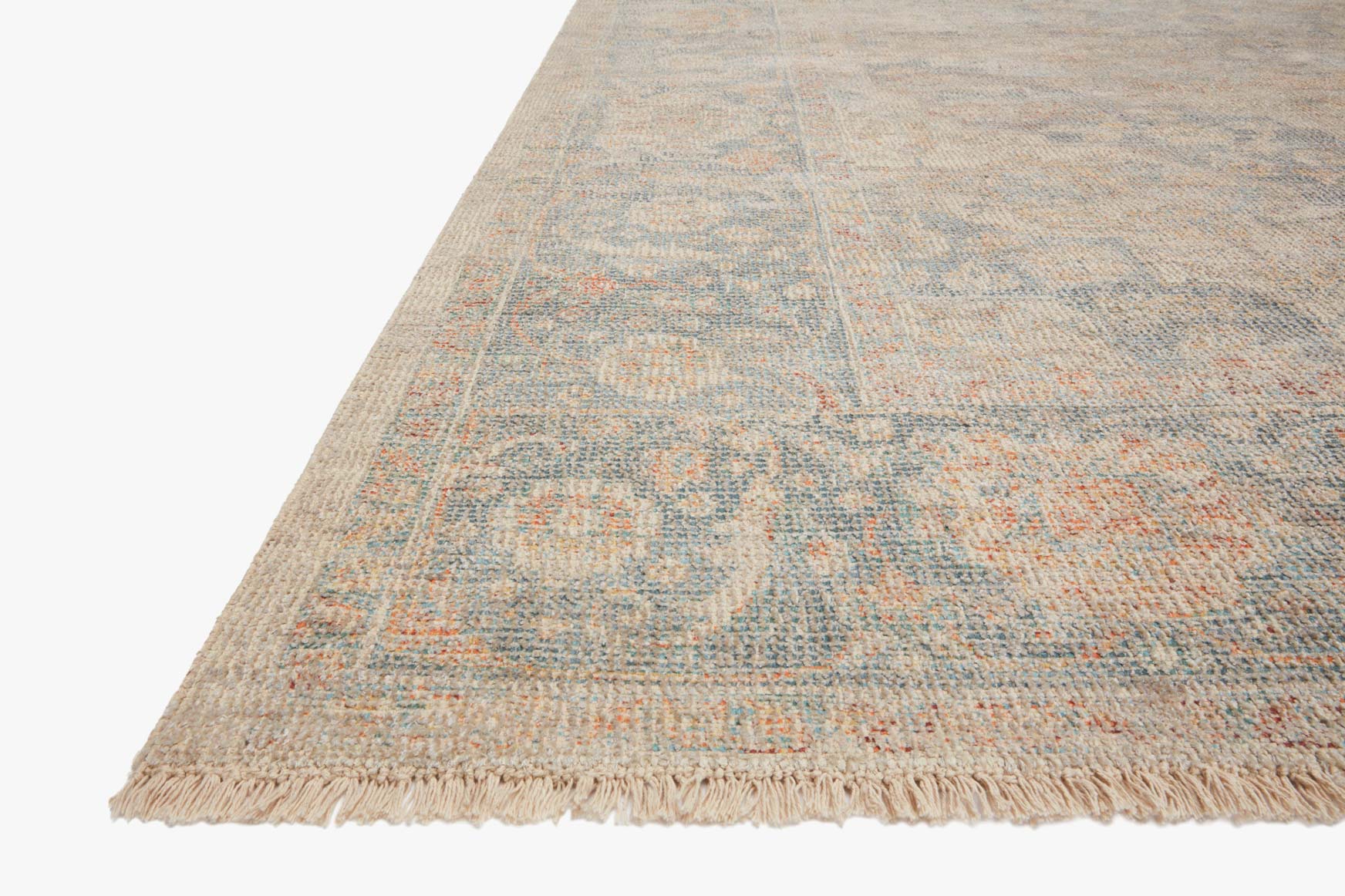 Hand-woven rug corner with short fringe, bone base and blue-gray distressed motif