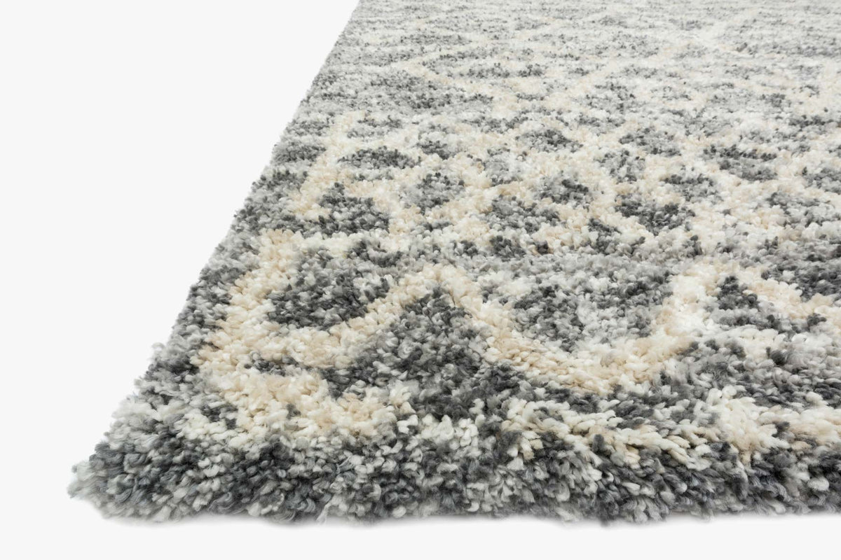 Shag rug corner with thick pile; graphite gray and light beige blended pattern