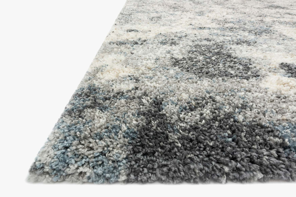 Corner detail of slate shag power-loomed rug, dense short pile in gray and cream