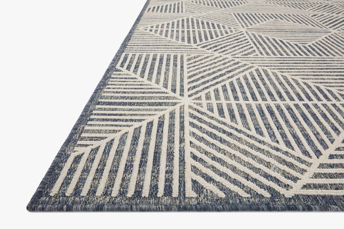 Denim and ivory geometric rug corner, close-up of striped and lattice pattern