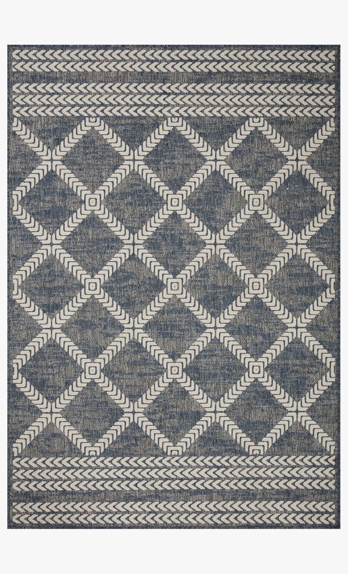Denim blue and ivory indoor/outdoor power-loomed rug with diamond geometric pattern.