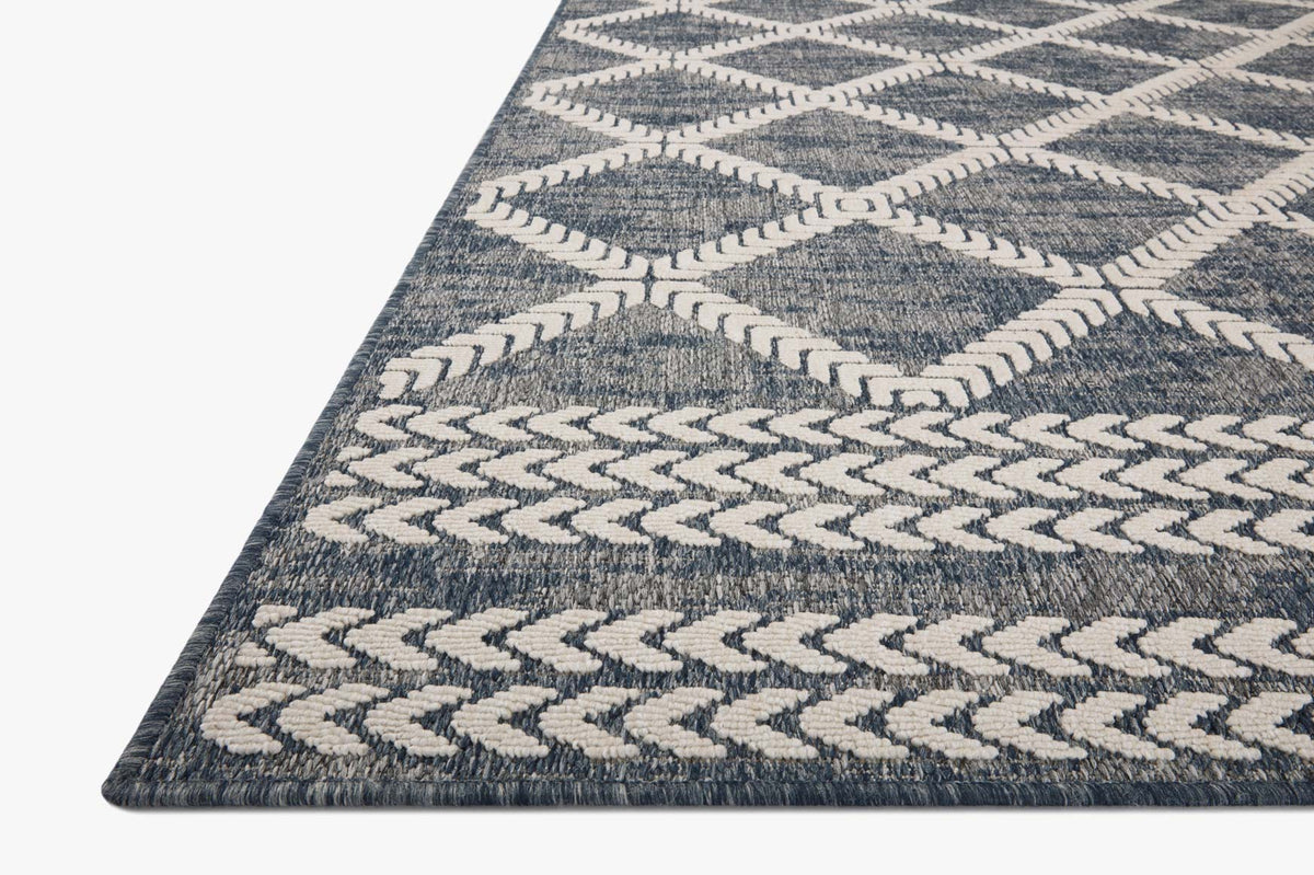 Denim blue and ivory power-loomed rug with repeating geometric motif.