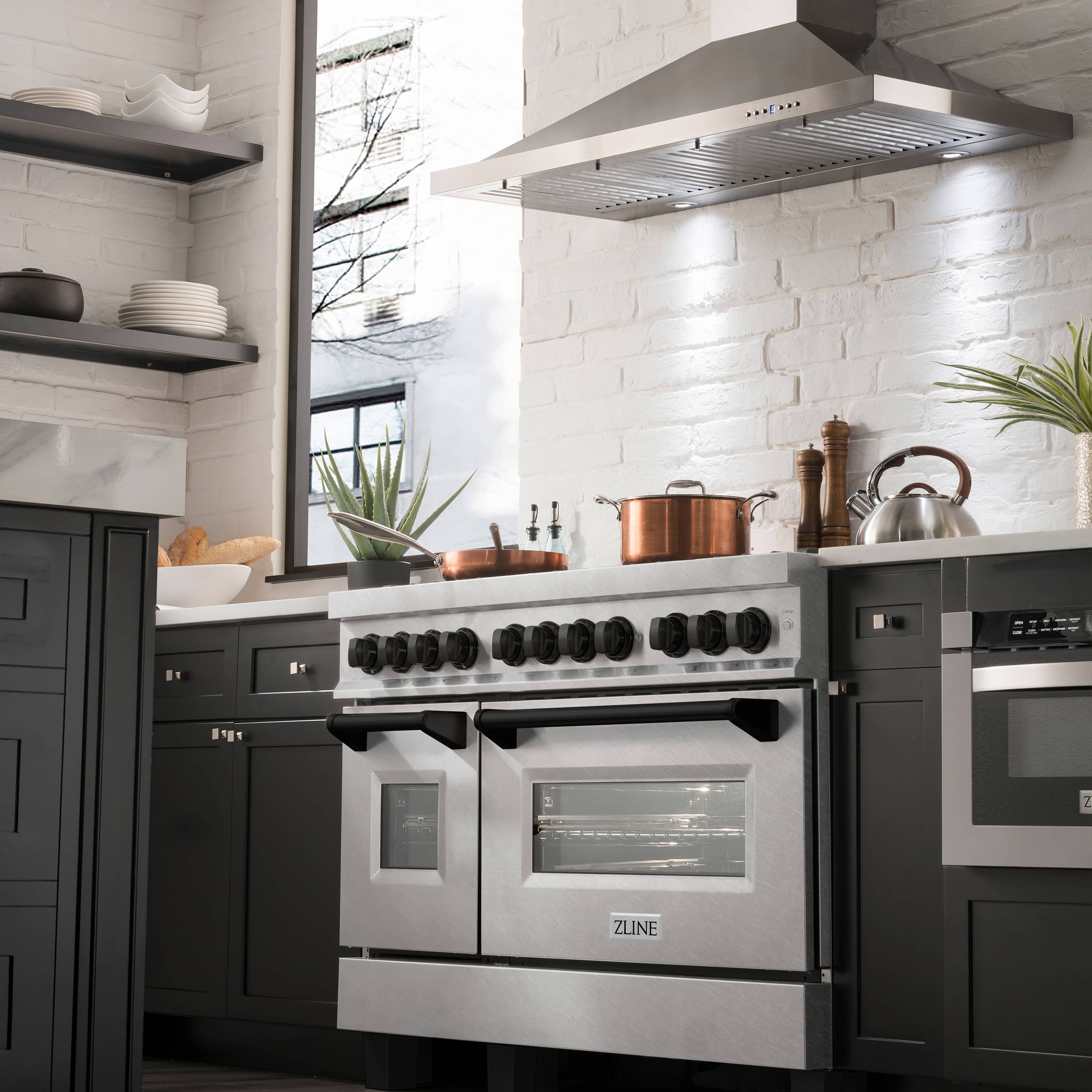 Dual-fuel range with stainless finish, black grates, and control knobs
