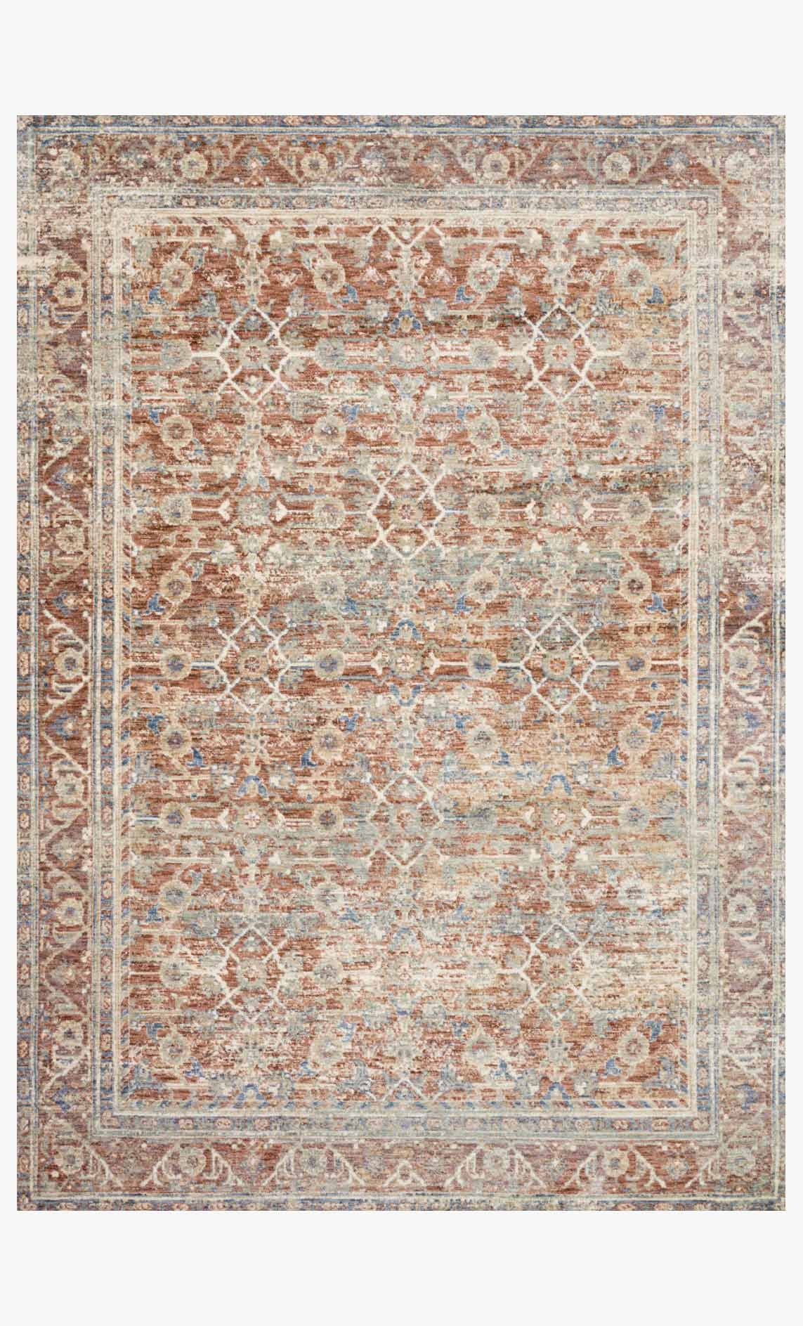 Traditional power-loomed rug with terracotta, beige, and blue geometric border