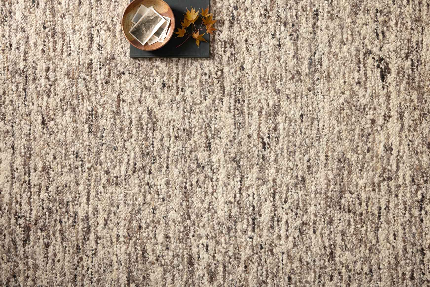 Textured granite and mocha rug surface with speckled vertical pattern