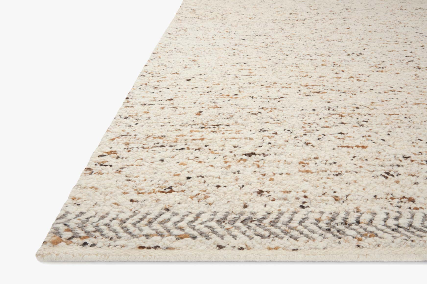 Beige speckled hand-woven rug with angled corner view and short fringe trim