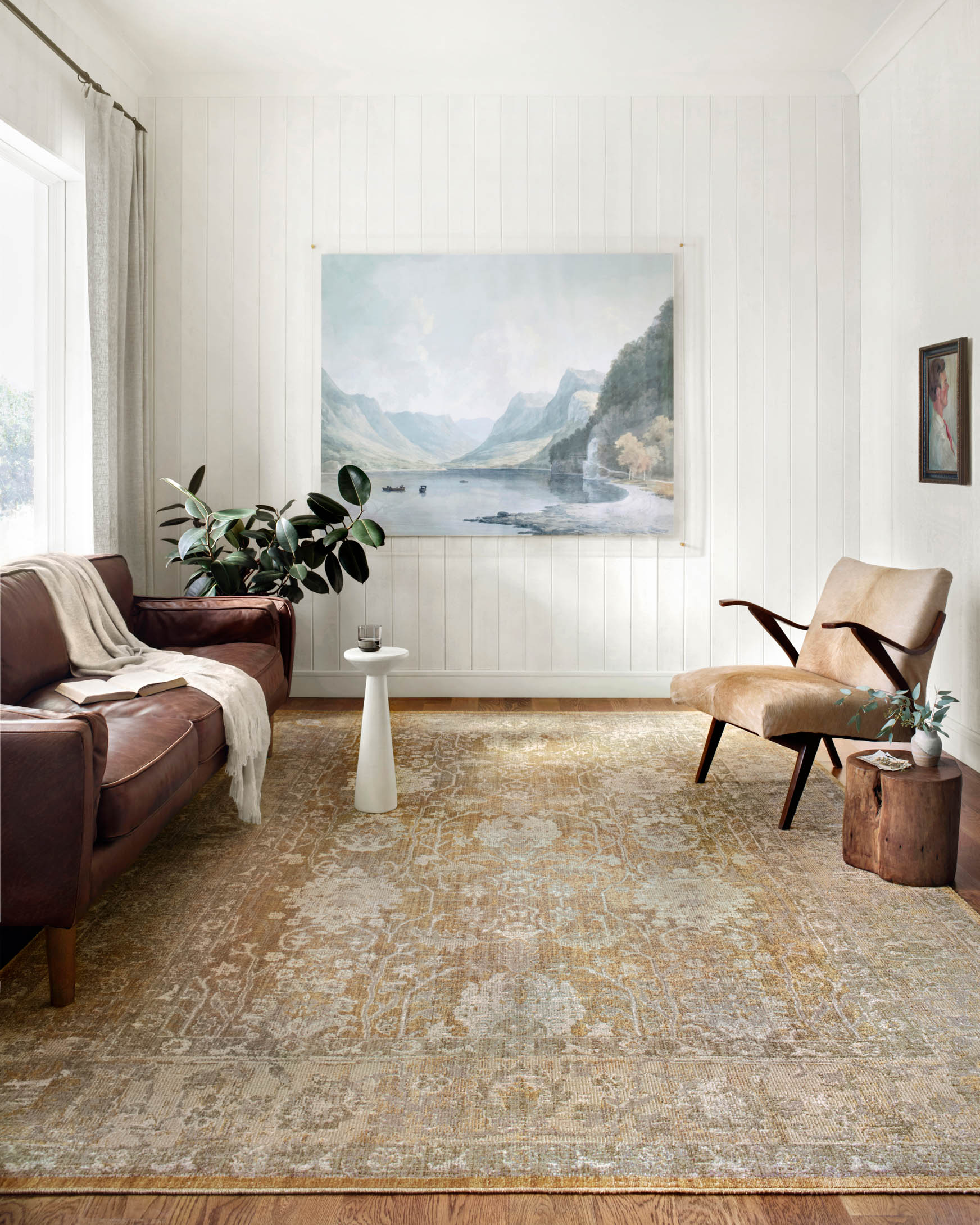 Gold and sand area rug with distressed ornamental design and rectangular border