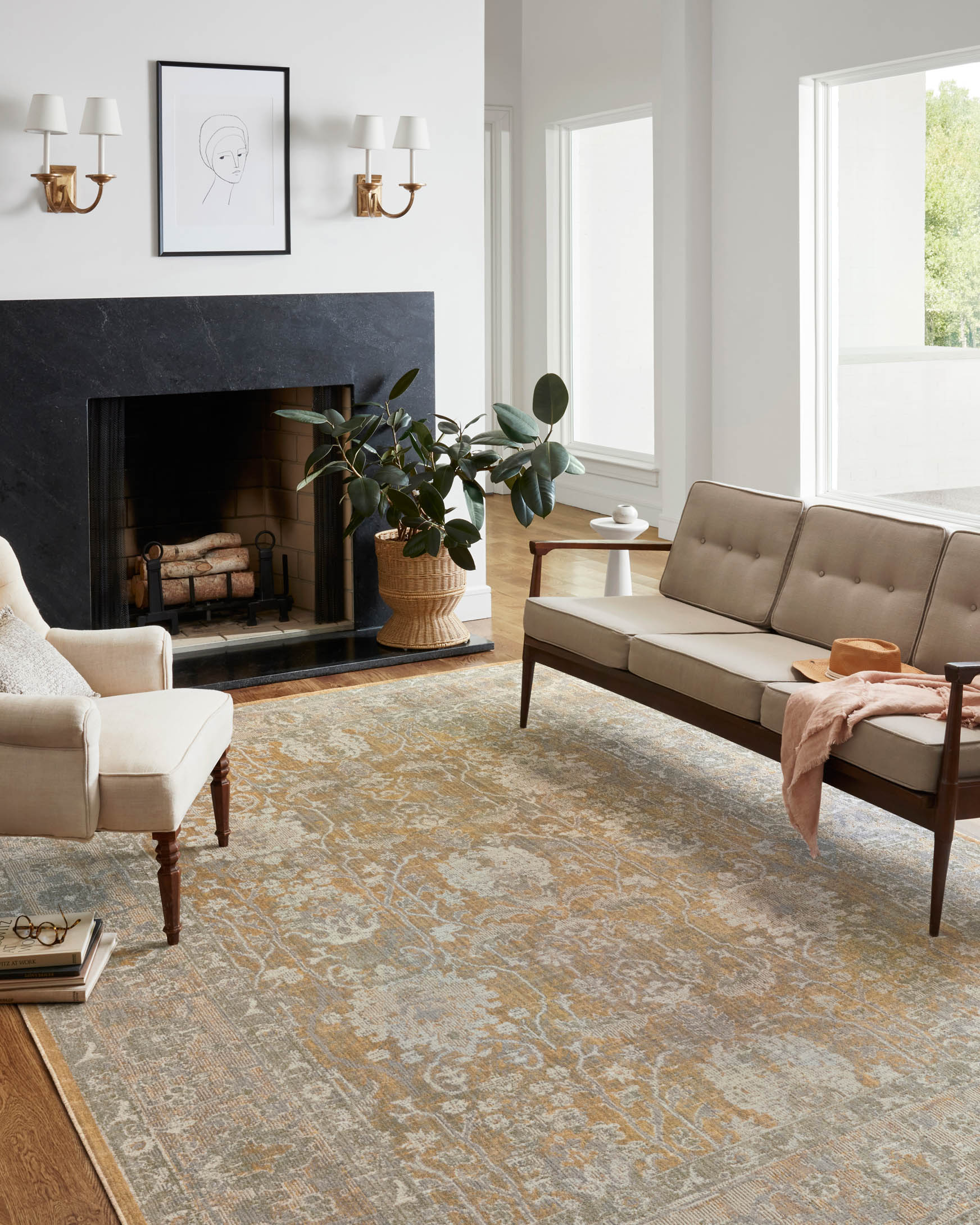 Gold and sand traditional power-loomed rug with detailed pattern, shown across a living room floor