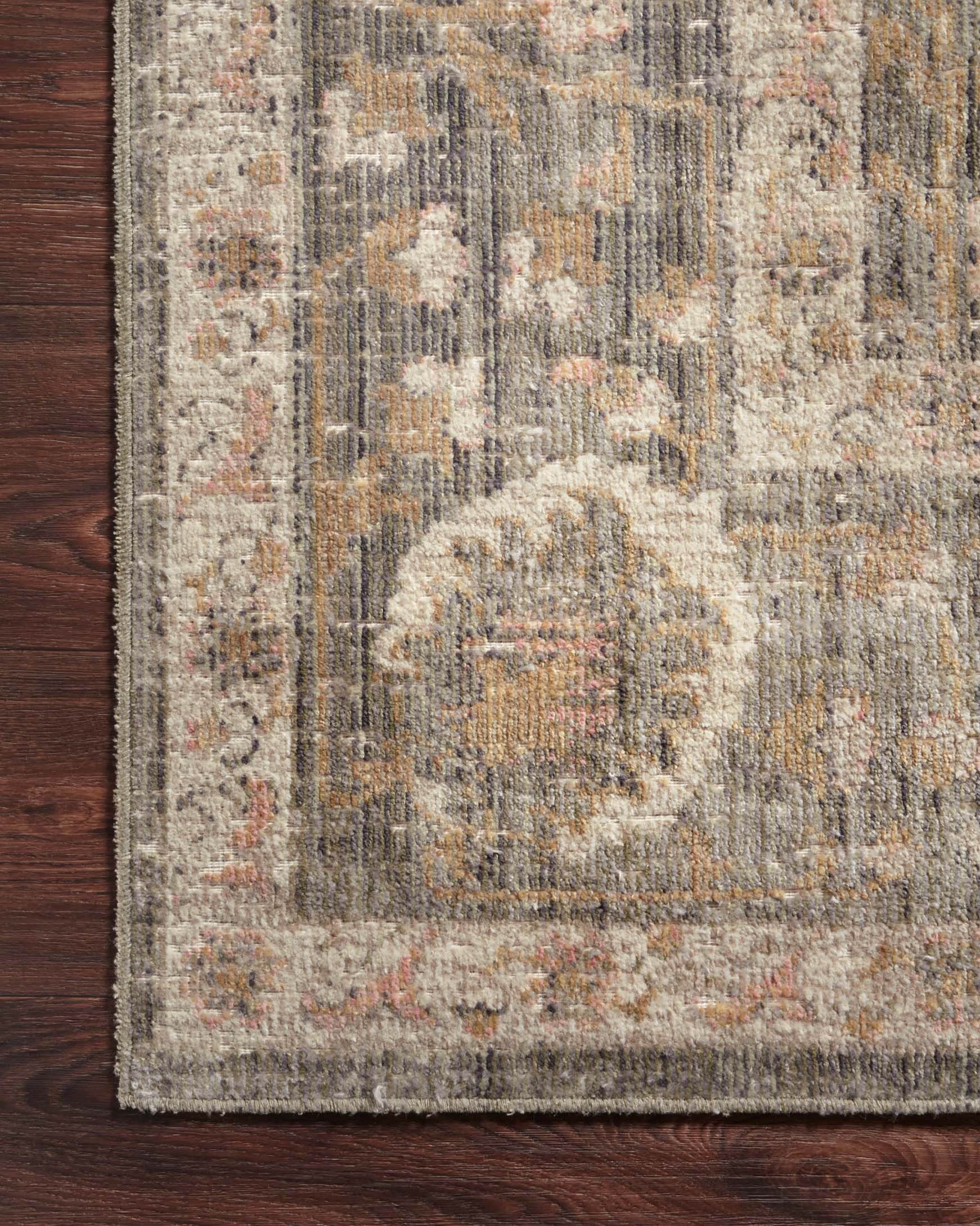 Traditional power-loomed rug with cream medallion, sage and blush abstract pattern.