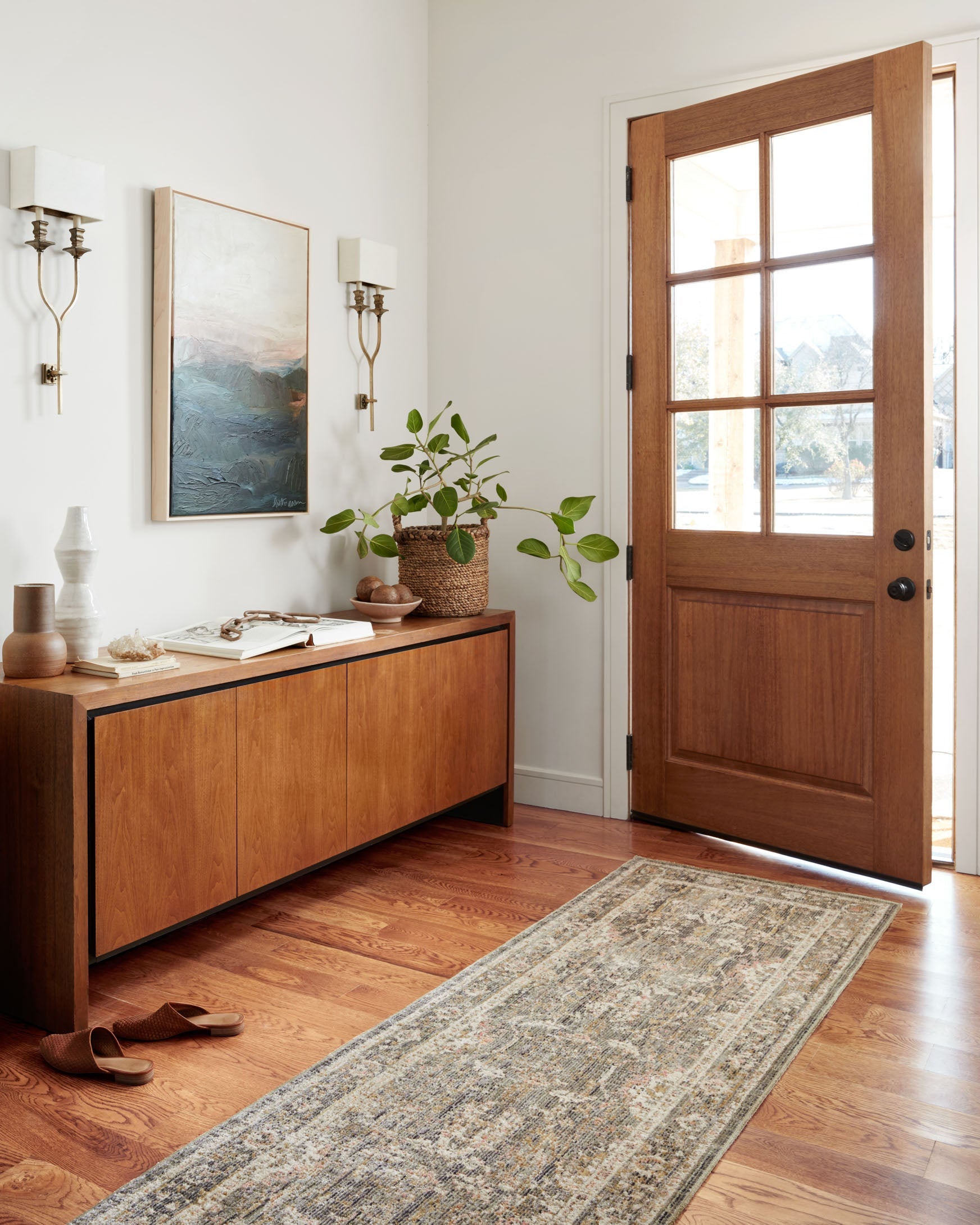 Traditional rug runner with ornate border and vintage pattern in sage and blush tones.