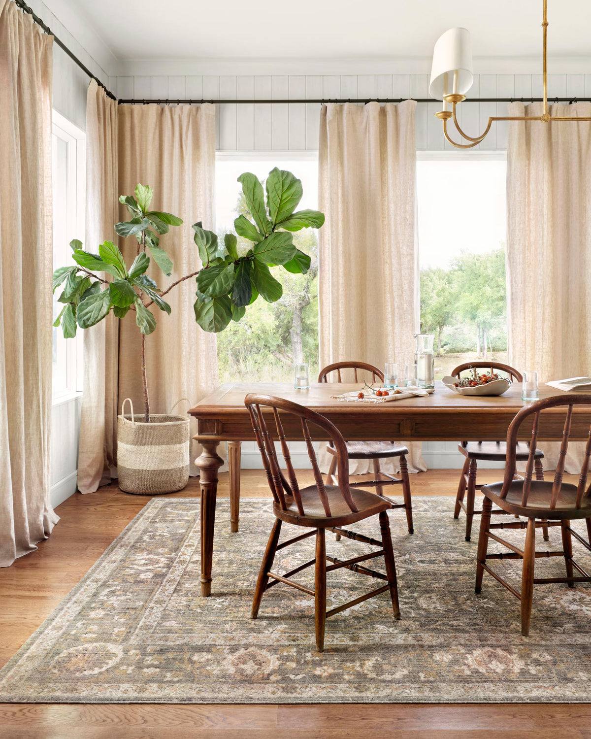 Traditional area rug with vintage-style medallion pattern in muted sage and blush hues.