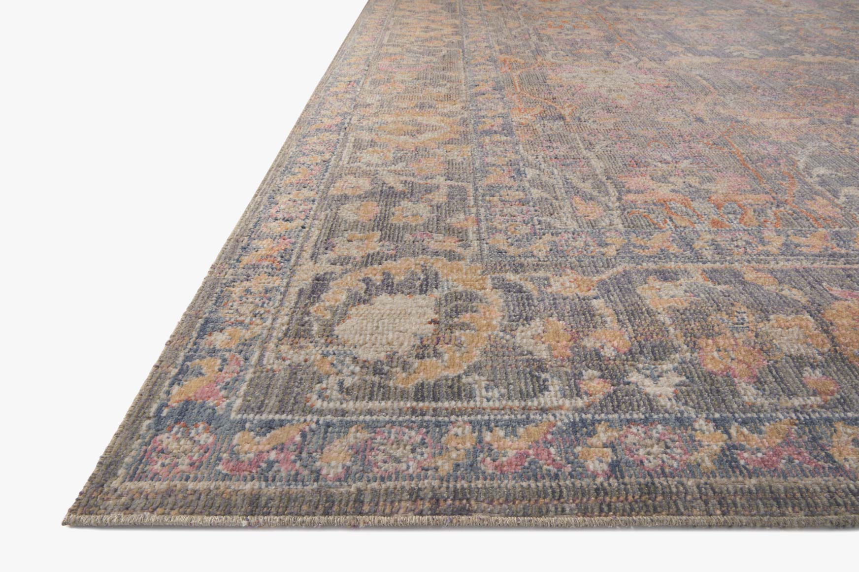 Corner detail of stone-toned traditional power-loomed rug with multicolor motif