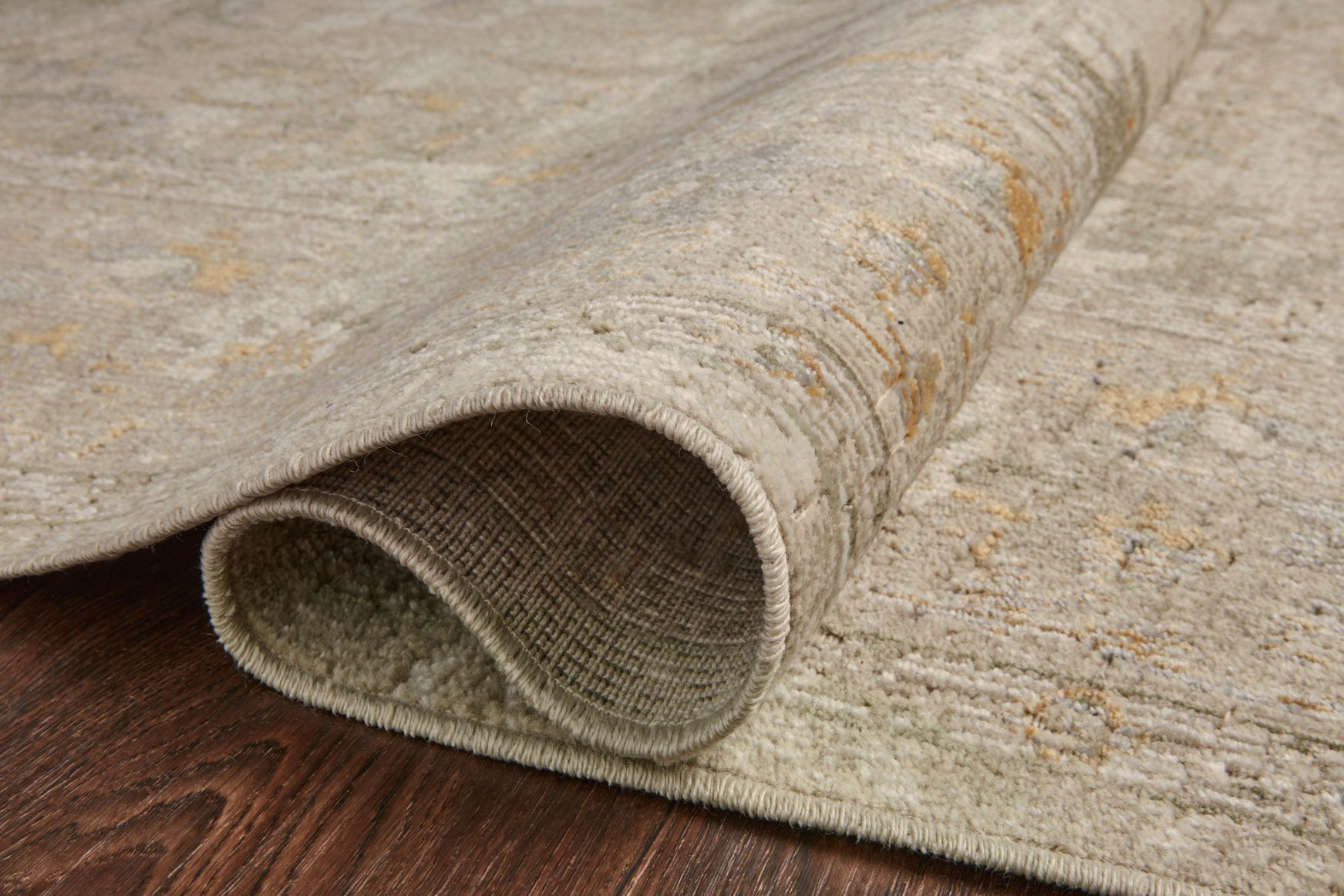 Ivory and natural rug with rolled border edge and low textured pile