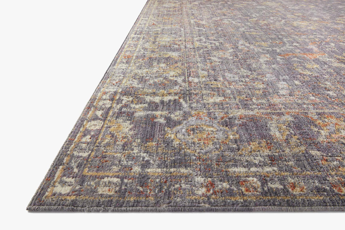 Traditional power-loomed area rug corner view with distressed geometric design