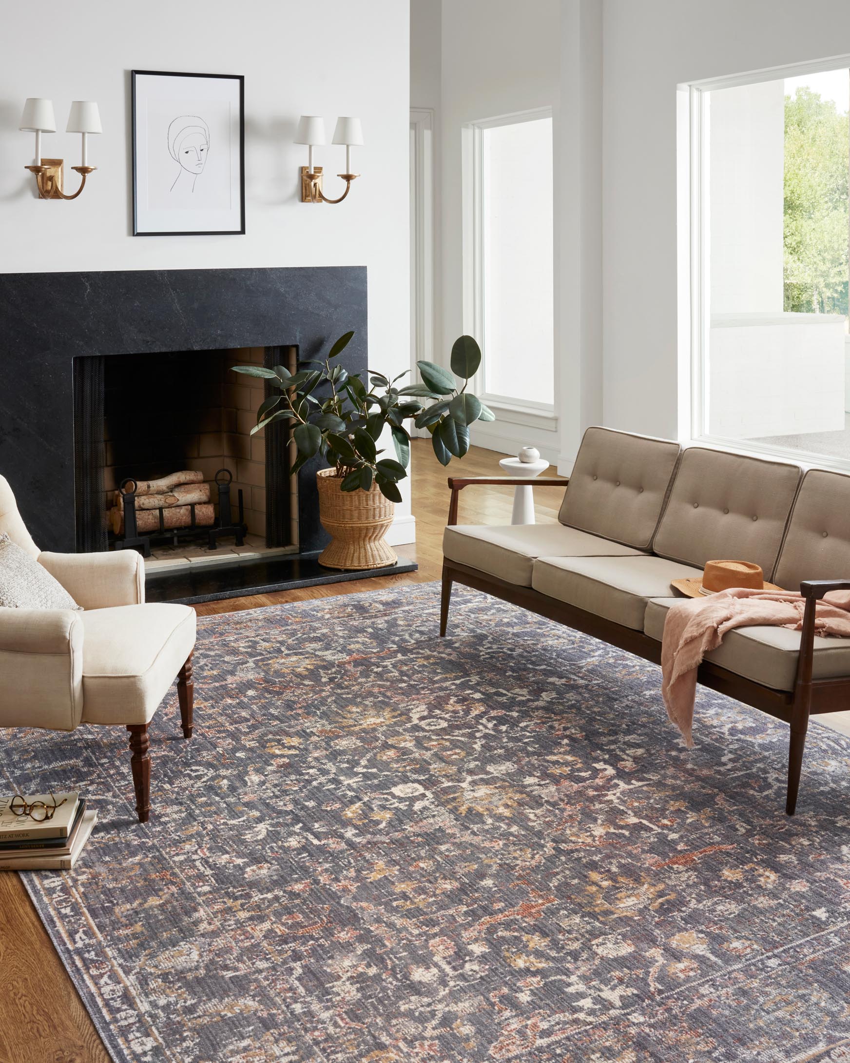 Graphite abstract area rug with distressed motifs, shown in a living room setting.