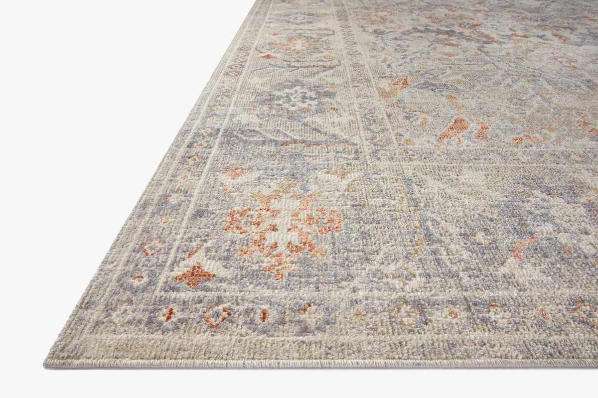 Traditional power-loomed rug corner close-up in oatmeal, with lavender and orange motif detail