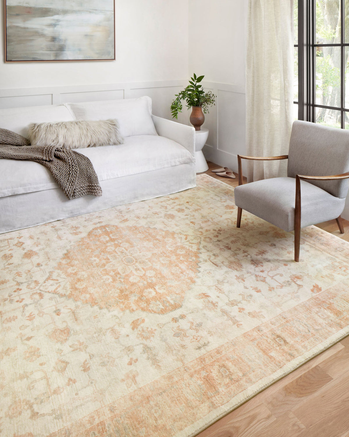 Ivory area rug with ornate medallion pattern and terracotta-toned accents