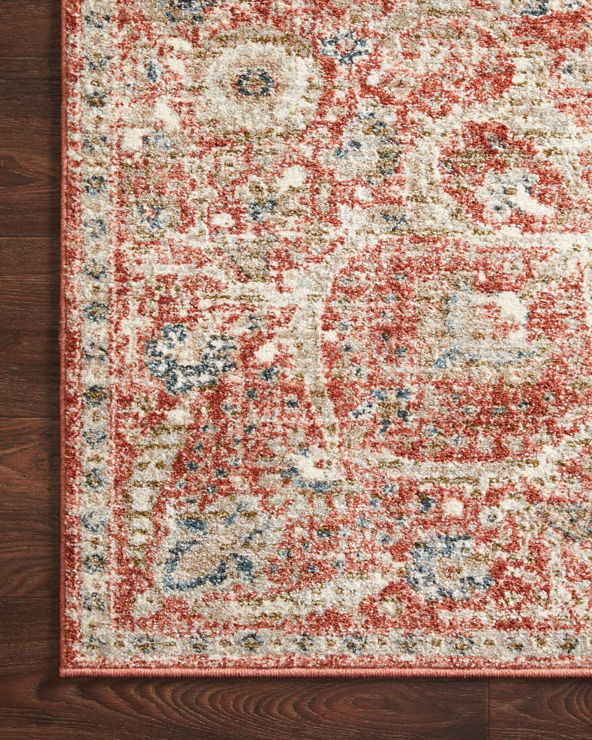 Rust and beige rug close-up with distressed ornamental motifs
