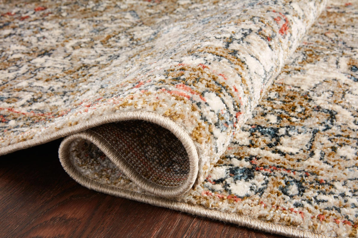 Beige patterned rug with rolled edge, textured border showing rug thickness
