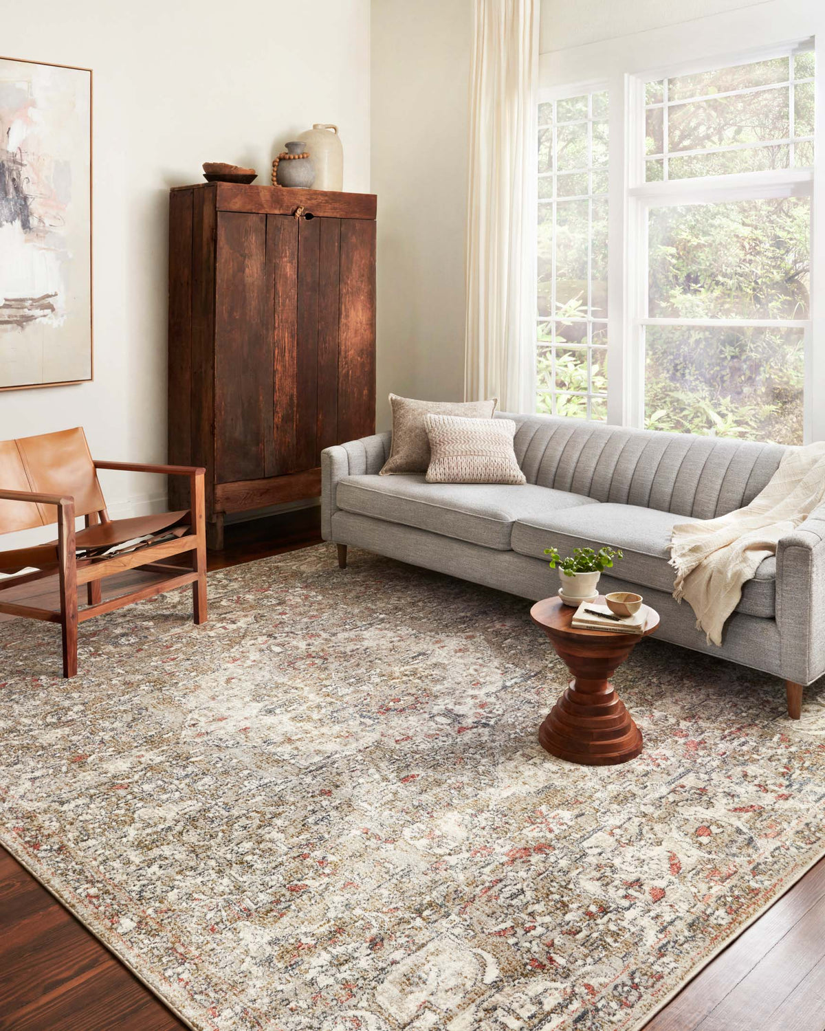 Beige and multicolor vintage-style area rug with detailed border and central motif.
