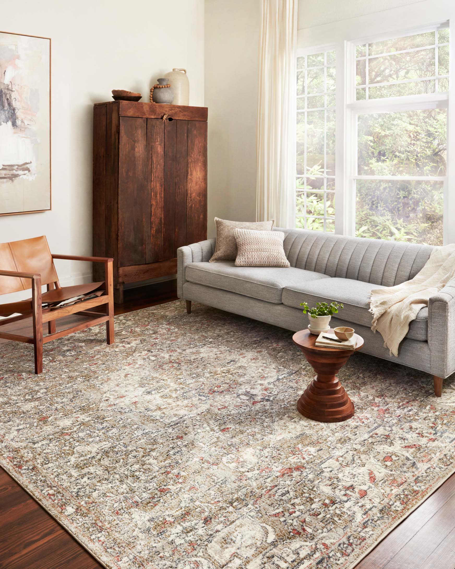 Ornate beige and multicolor area rug with rectangular border design