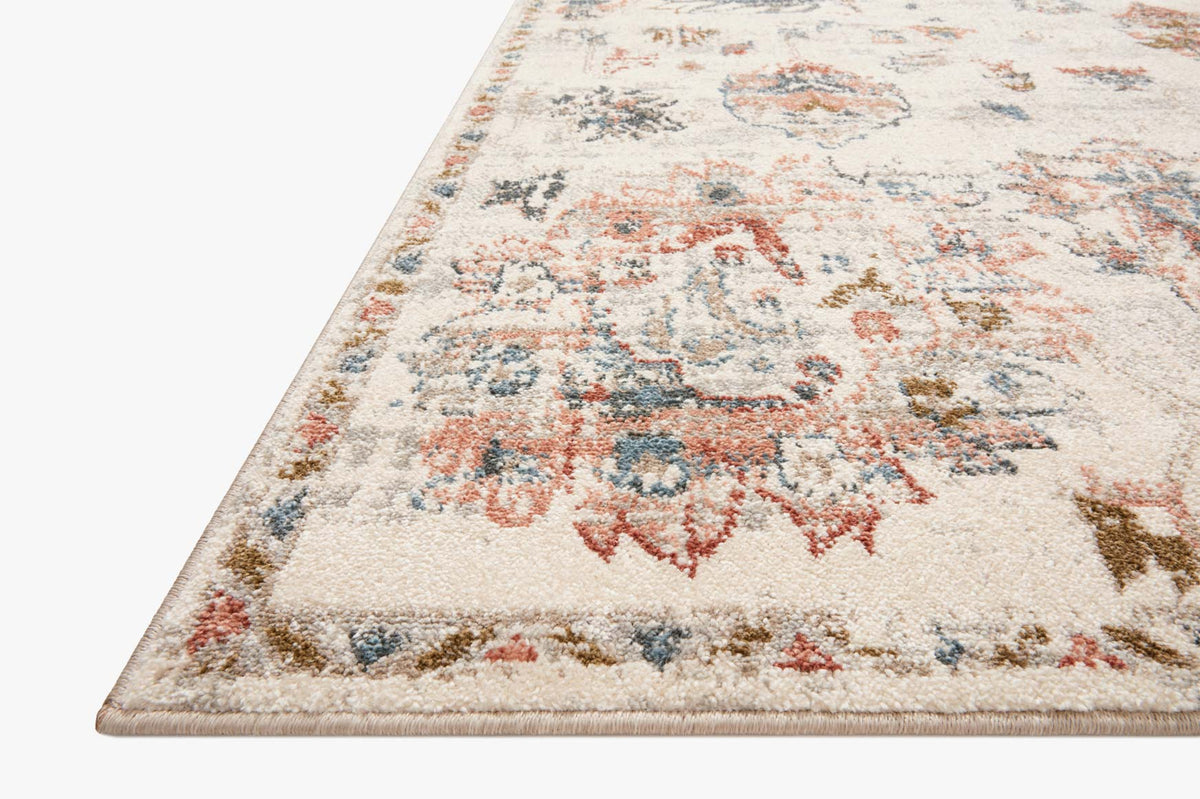 Ivory area rug with distressed multicolor medallion and ornate border