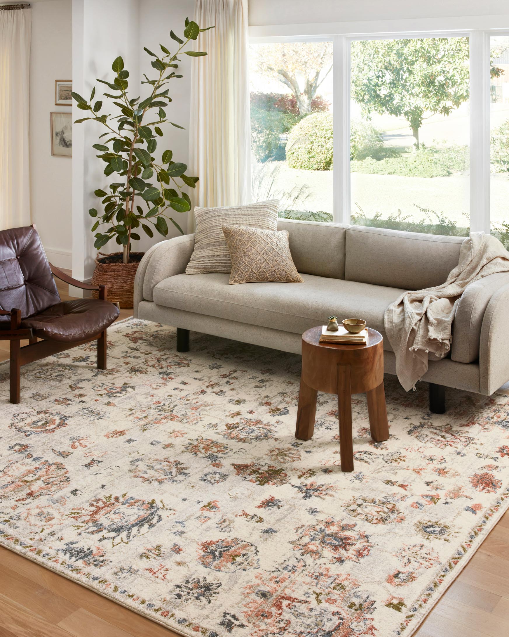 Ivory traditional rug with multicolor floral and geometric motifs