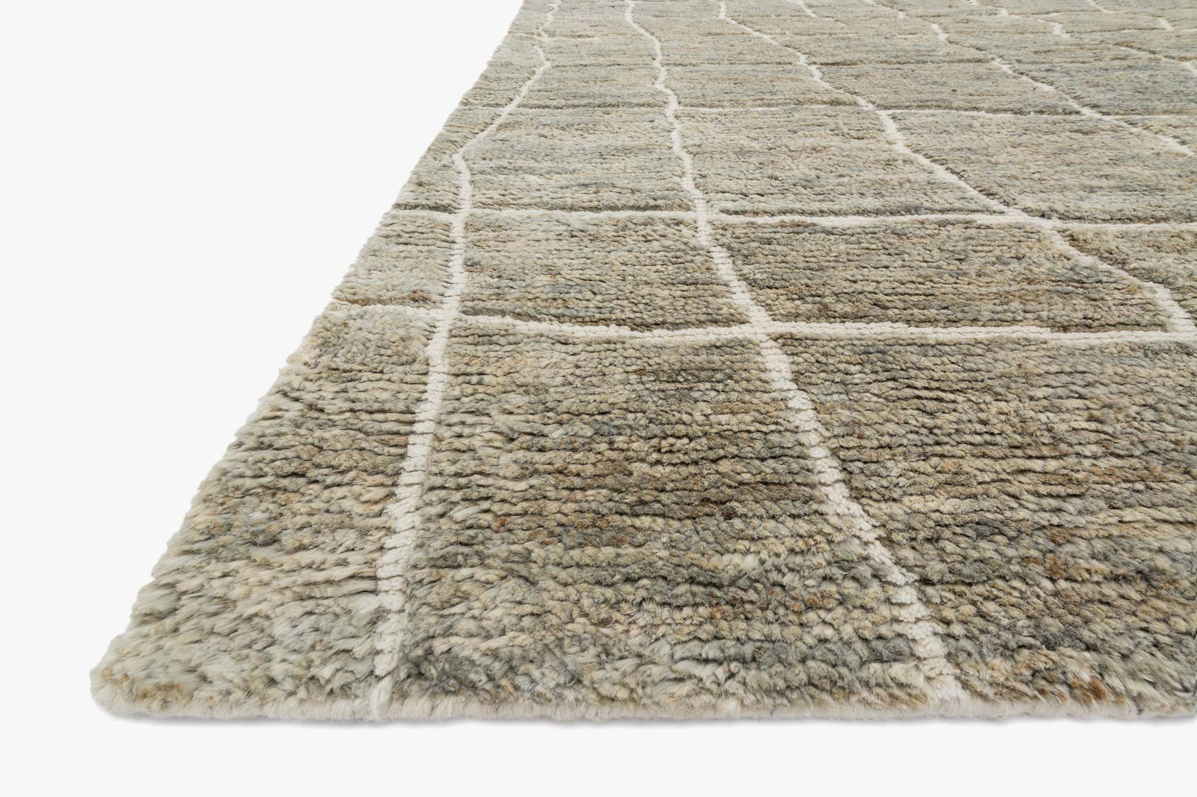 Hand-knotted rug corner with textured pile and geometric grid in birch and gray