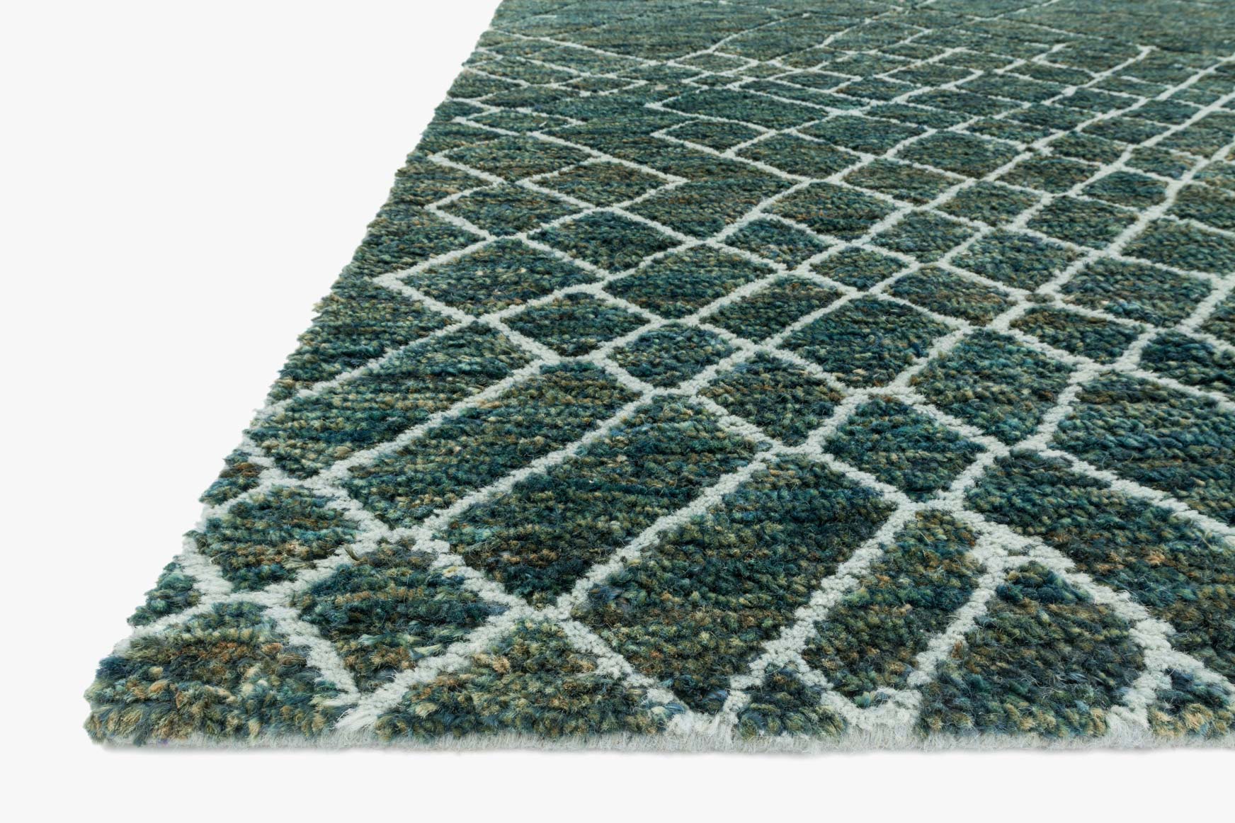 Corner view of teal rug with white geometric diamond lattice and textured pile