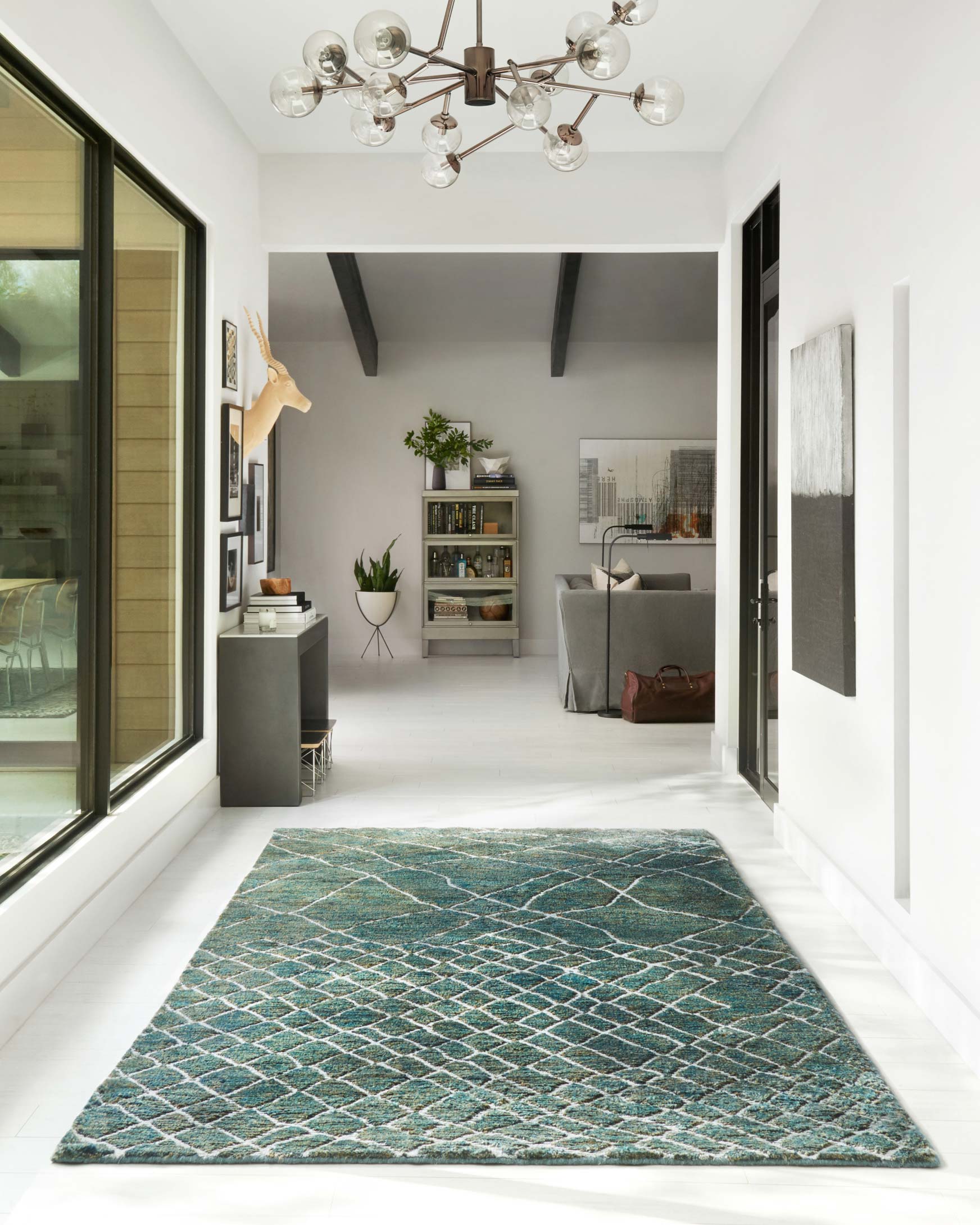 Rectangular teal area rug with white lattice diamond pattern