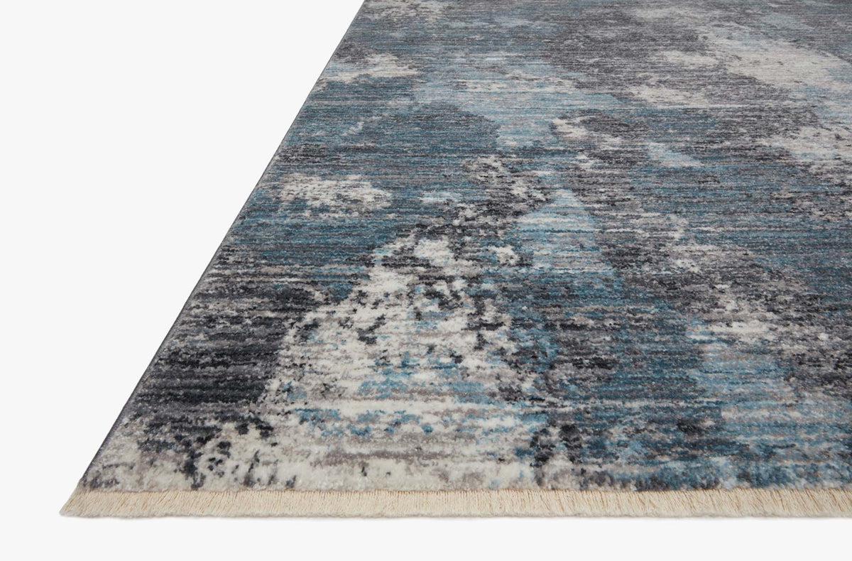 Blue and dove abstract rug corner with short fringe, rectangular.