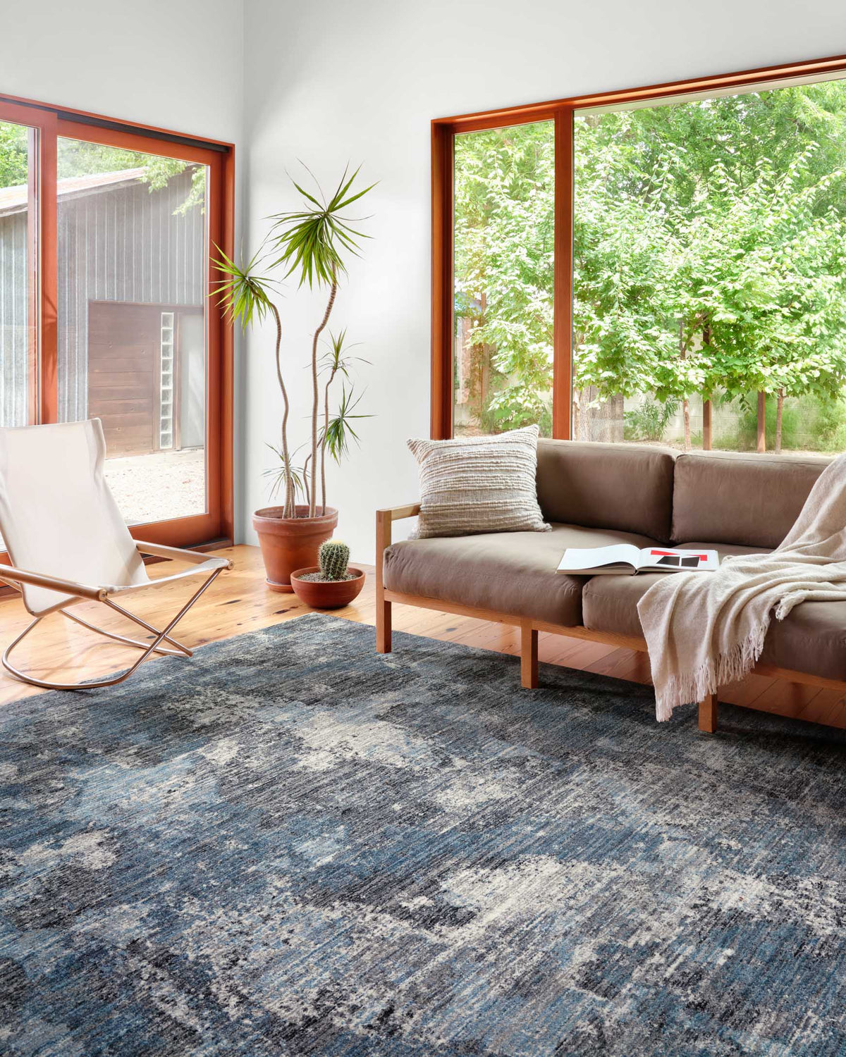 Blue and dove abstract distressed area rug on floor, rectangular.