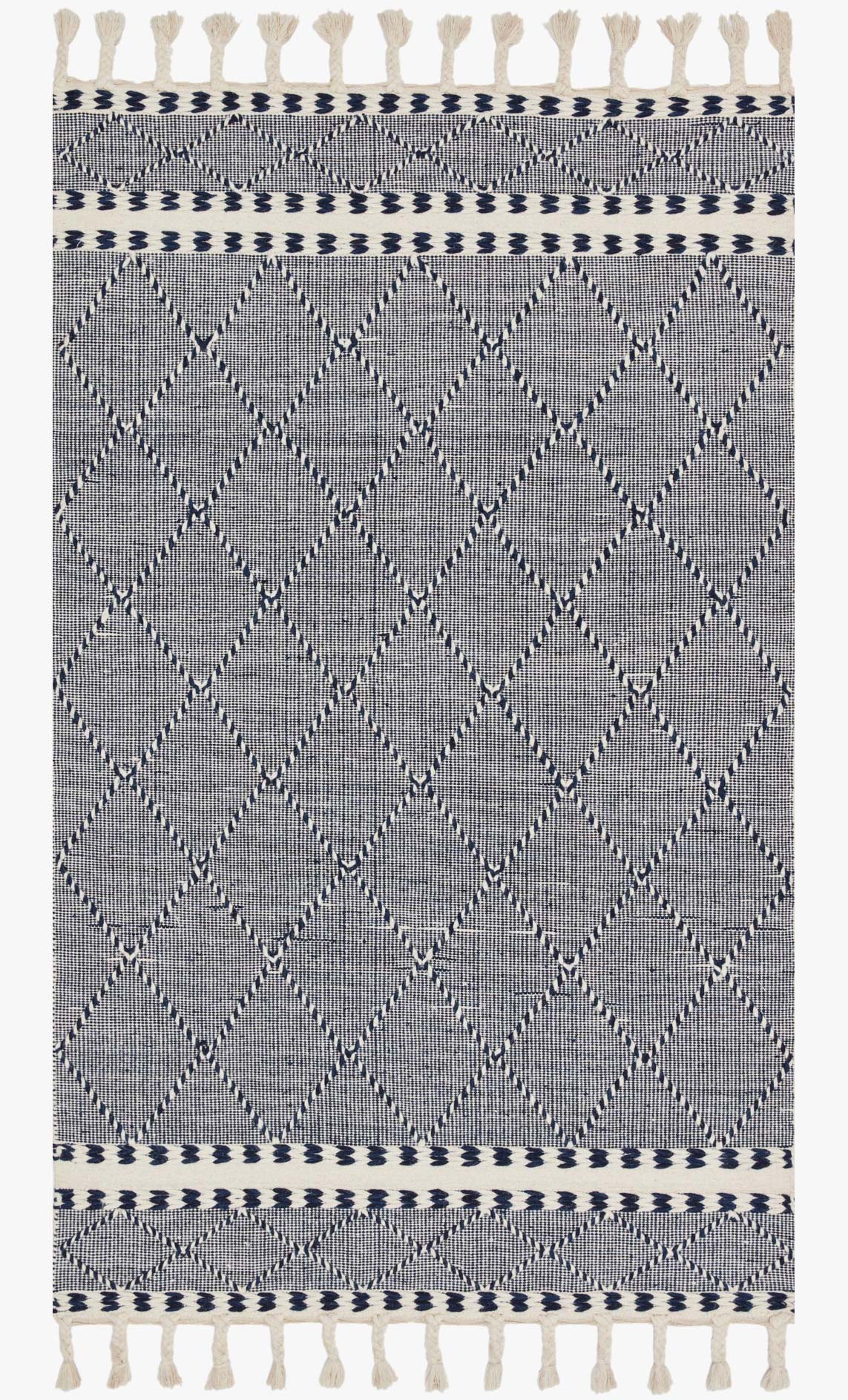 Rug in navy and off-white with repeating diamond pattern and fringed border