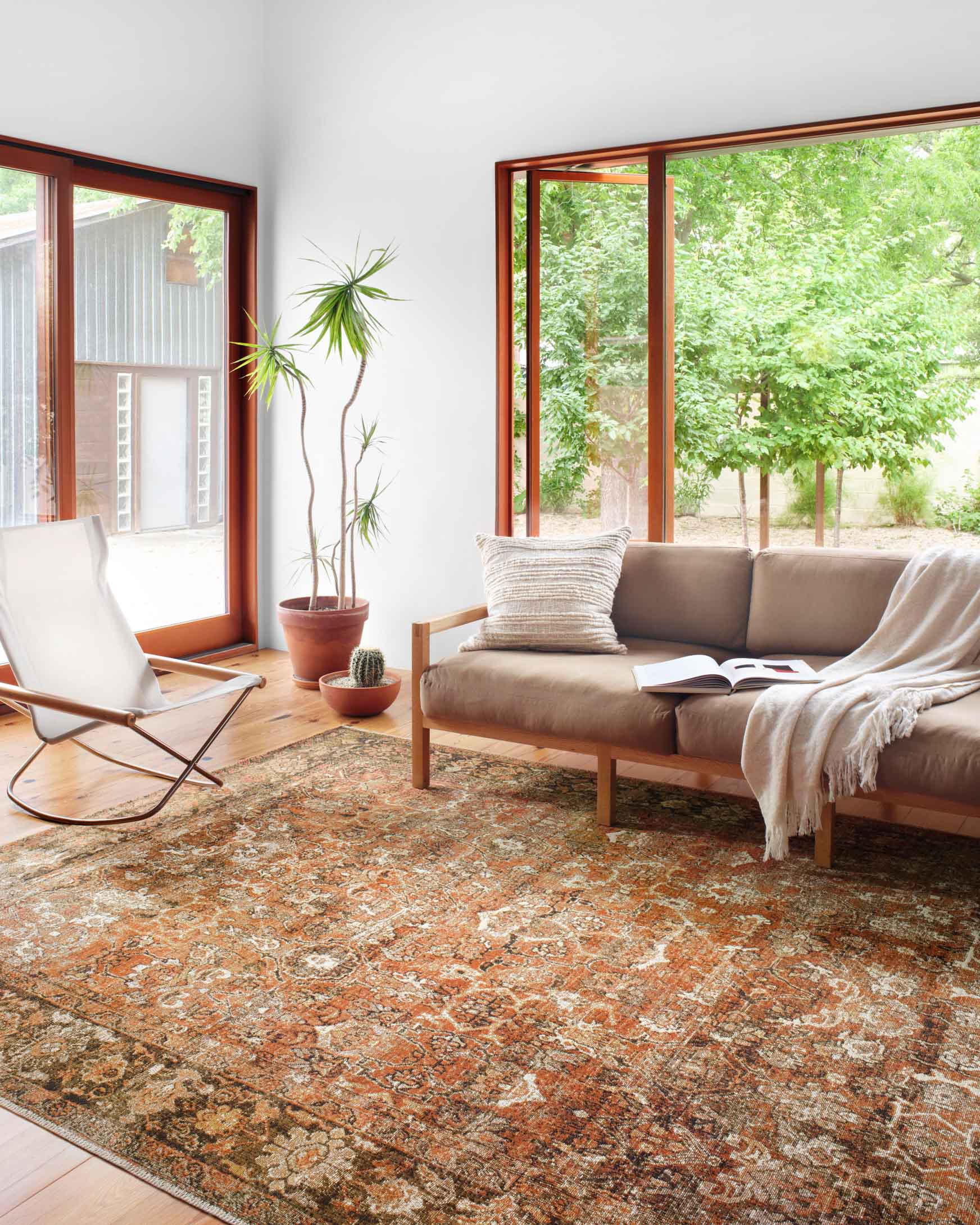 Traditional power-loomed area rug in rust and tobacco with intricate central medallion
