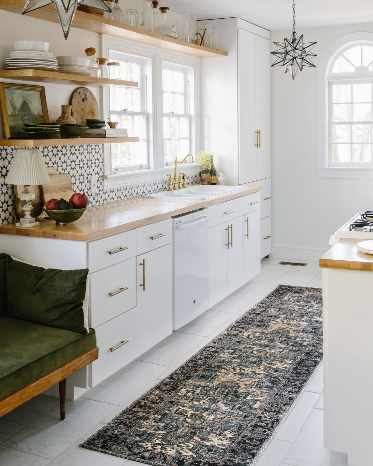 Blue and dark navy power-loomed rug with faded ornate design laid along the kitchen floor